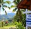 Beautiful Costa Rica property with owner financing sign in foreground
